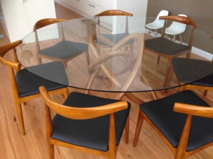 Glass top table with curved legs